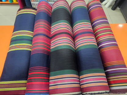 Rolls of colorful striped fabric on a flat surface